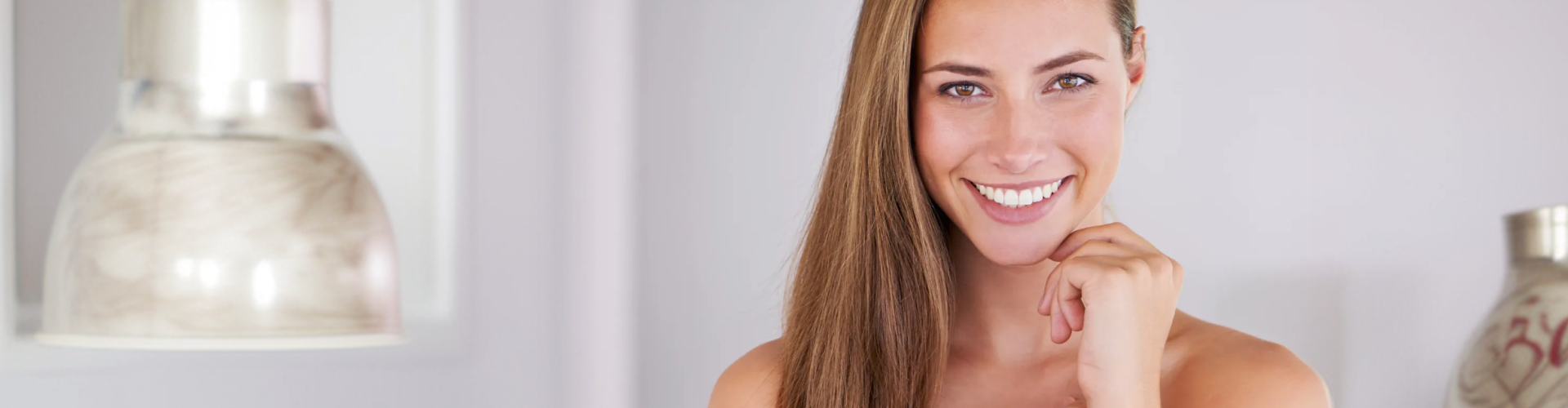 Woman smiling with bright, even teeth, showcasing a healthy and confident smile.